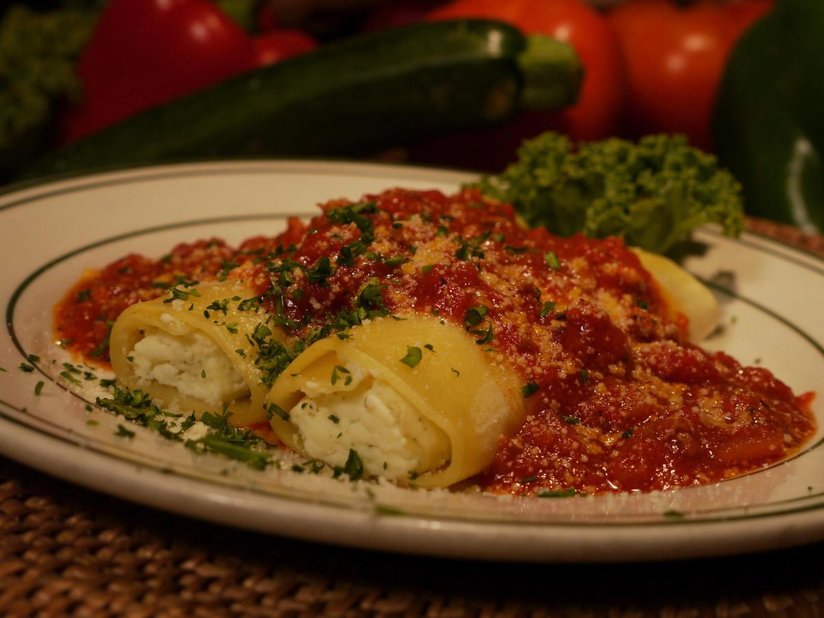 Traditional Italian meatballs garnished with fresh herbs and grated parmesan cheese